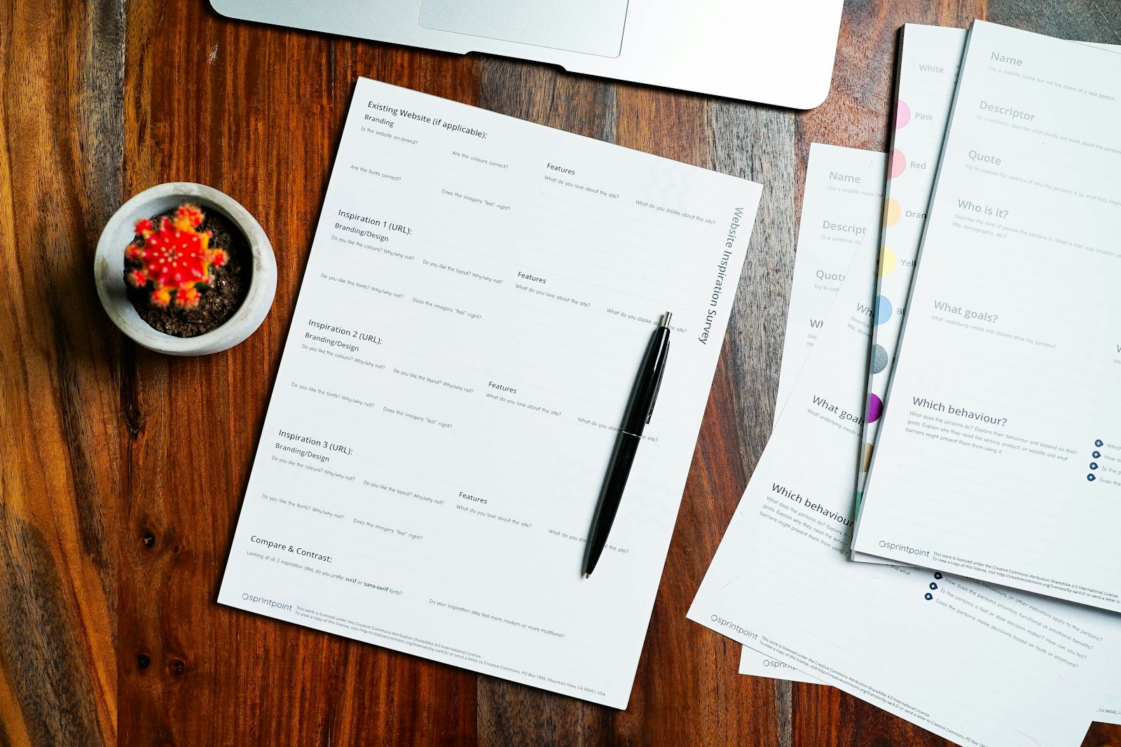 Printed documents and a pen on a wooden table